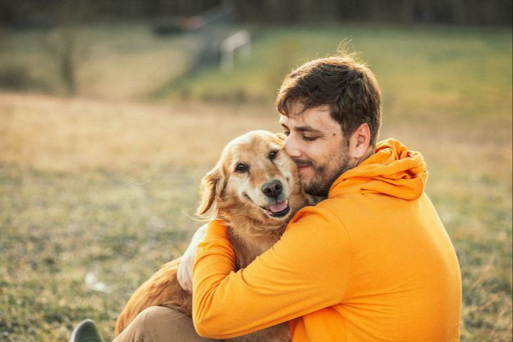 a person hugging a dog