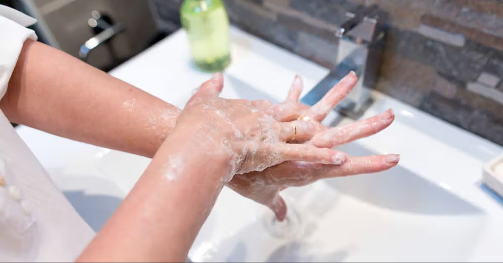 a person washing their hands thoroughly with soap