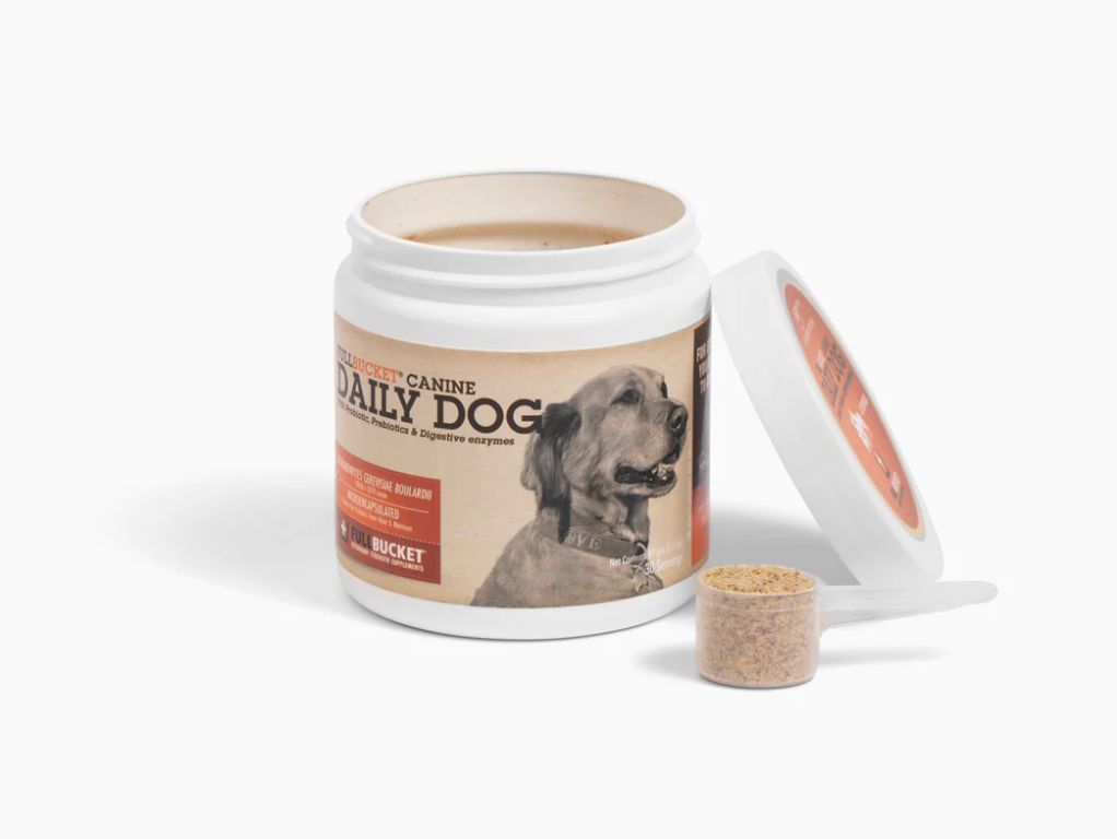a probiotic supplement container next to dog kibble