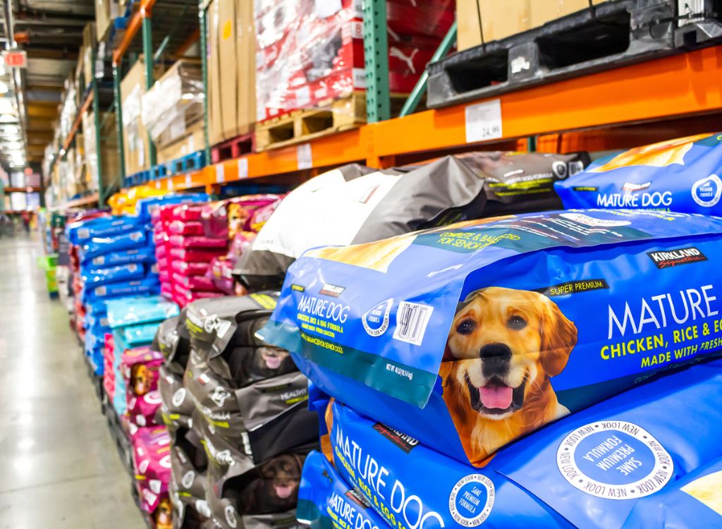 a shopper browsing the dog food selection at their local costco warehouse.