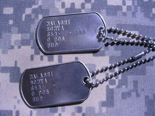 a soldier wearing standard-issue dog tags around the neck.