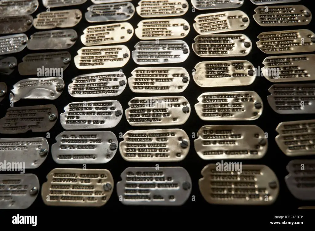 historic wwii dog tags on display in a military museum exhibit.