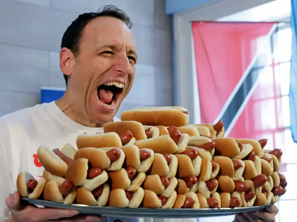 joey chestnut training for nathan's by rapidly eating hot dogs.