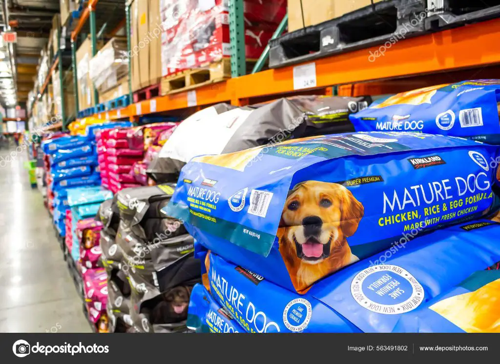 kirkland signature logo and dog food bags on display at a costco warehouse.