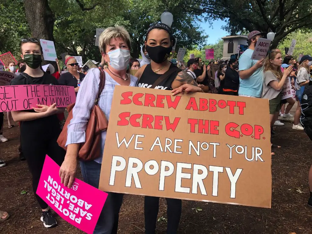 protestors with pro-choice signs outside texas state capitol building