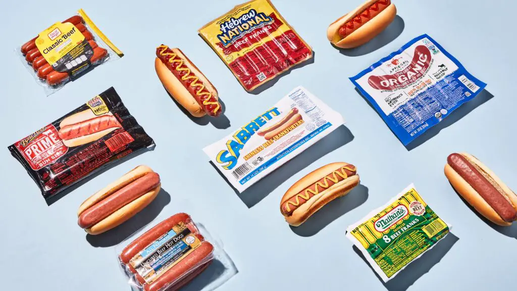 various hot dog brands and styles laid out at a summer barbecue.